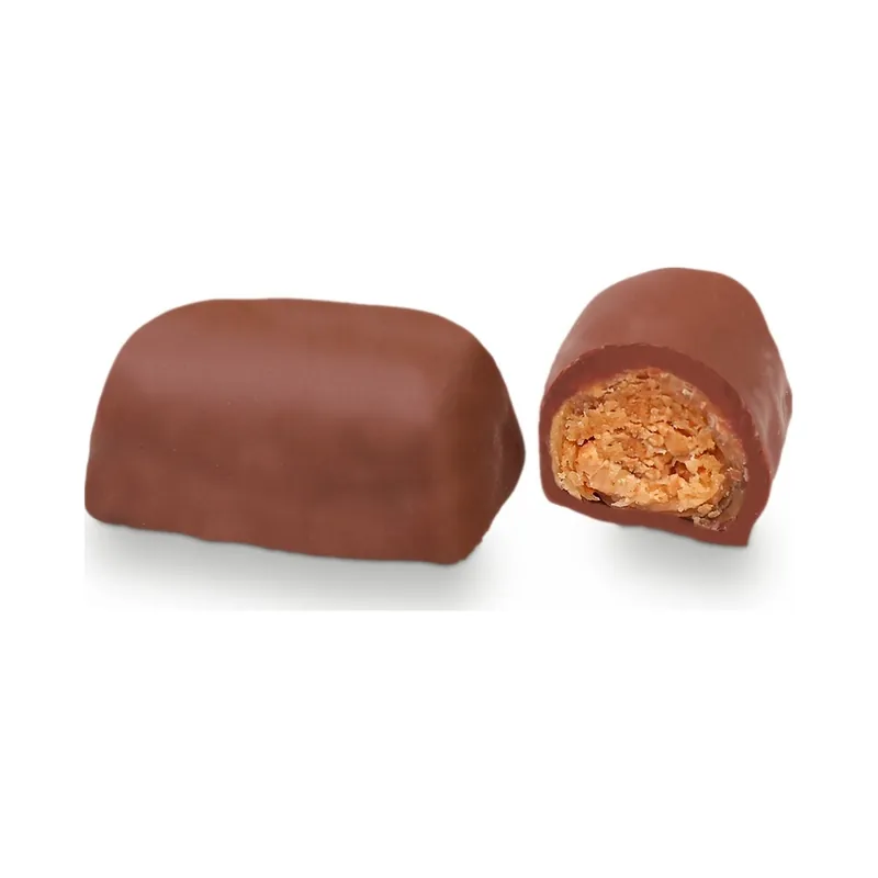 Milk chocolate bonbons, one cut to show a praline centre